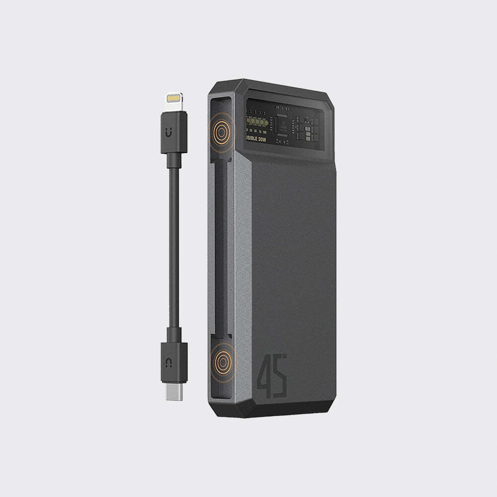 A dark gray portable power bank with a built-in cable, shown on a light gray background. The power bank features a digital display on the top panel, circular gold accents.