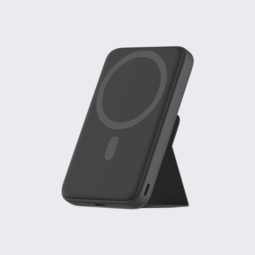 A black magnetic wireless charging case with an integrated kickstand, shown standing upright on a light gray background.