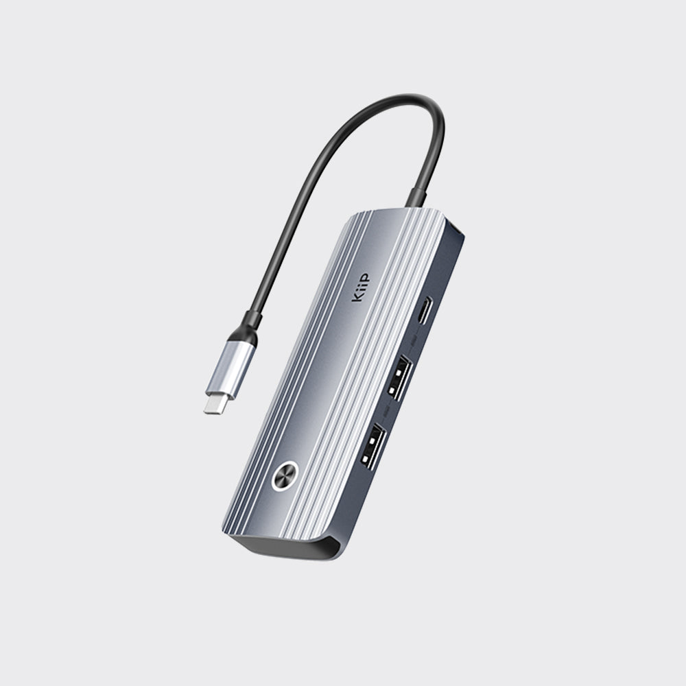 A silver and black Klip USB-C to HDMI adapter with a curved cable, shown on a light gray background.