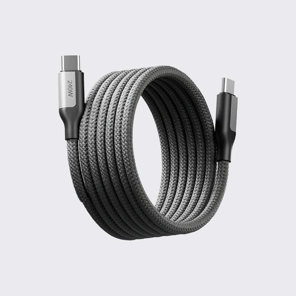 Coiled USB cable with metallic connectors on a light gray background
