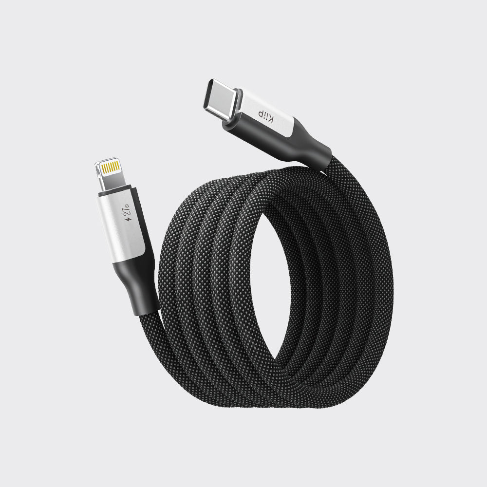 A coiled black braided USB-C to Lightning cable with silver metal connector housings, shown on a light gray background.