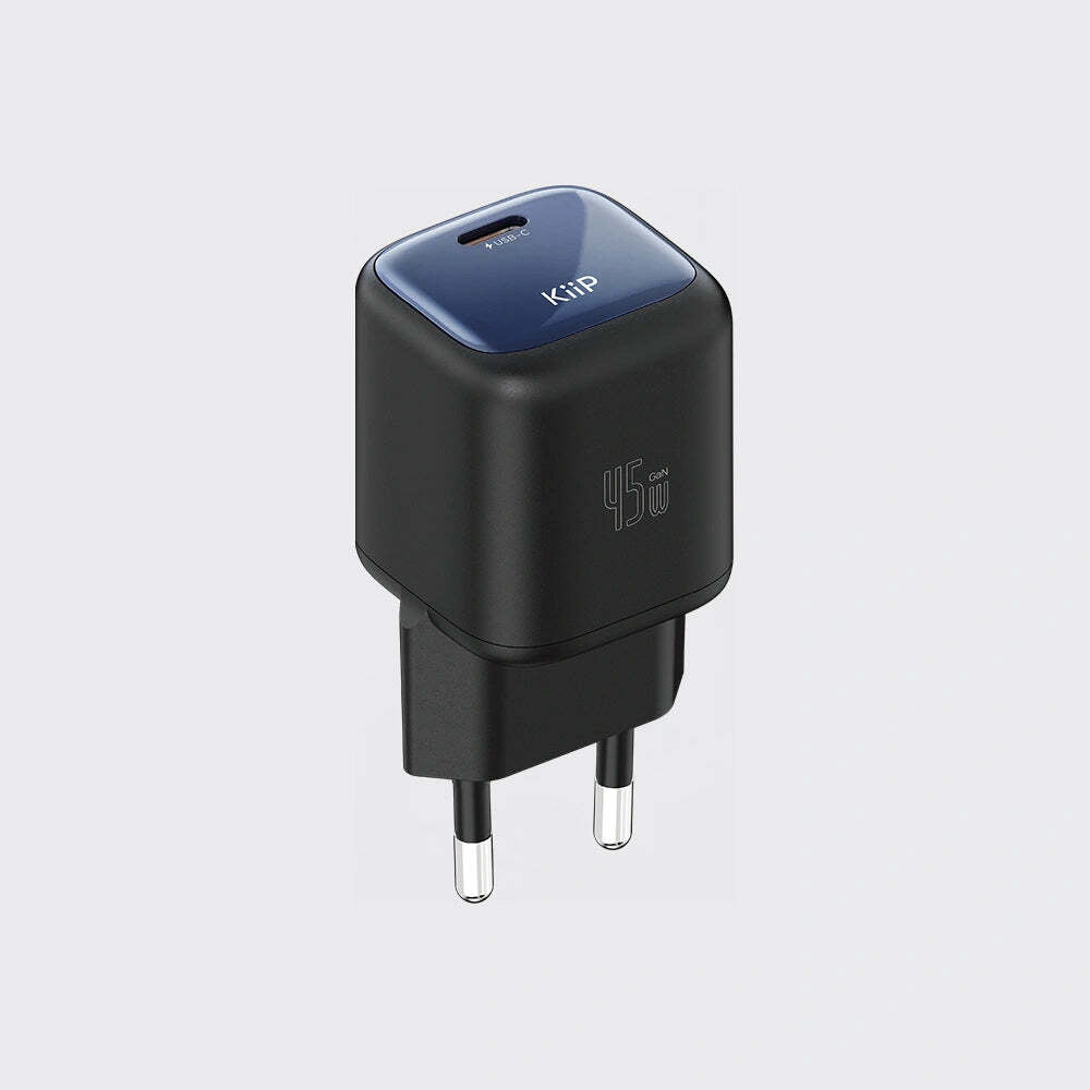 A compact black wall charger with a dark blue top panel, featuring USB-C and USB-A output ports, shown on a light gray background.