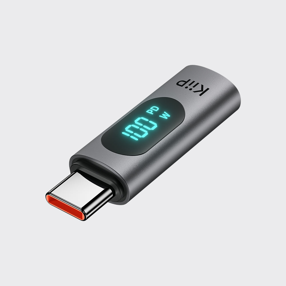 A sleek, metallic gray USB-C power bank with an integrated digital LED display showing 100W. The brand name 'Kip' is printed in white on the top surface.