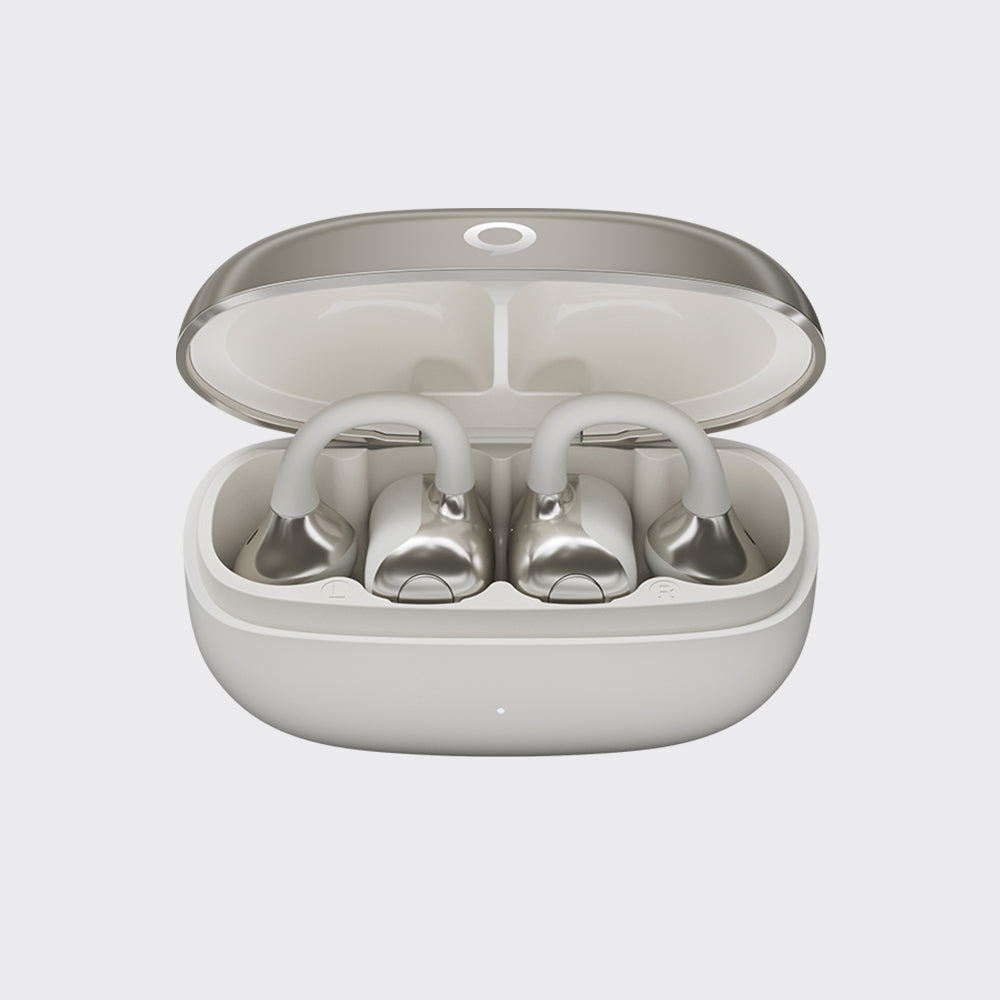 A pair of silver wireless earbuds resting inside an open white charging case on a light gray background.