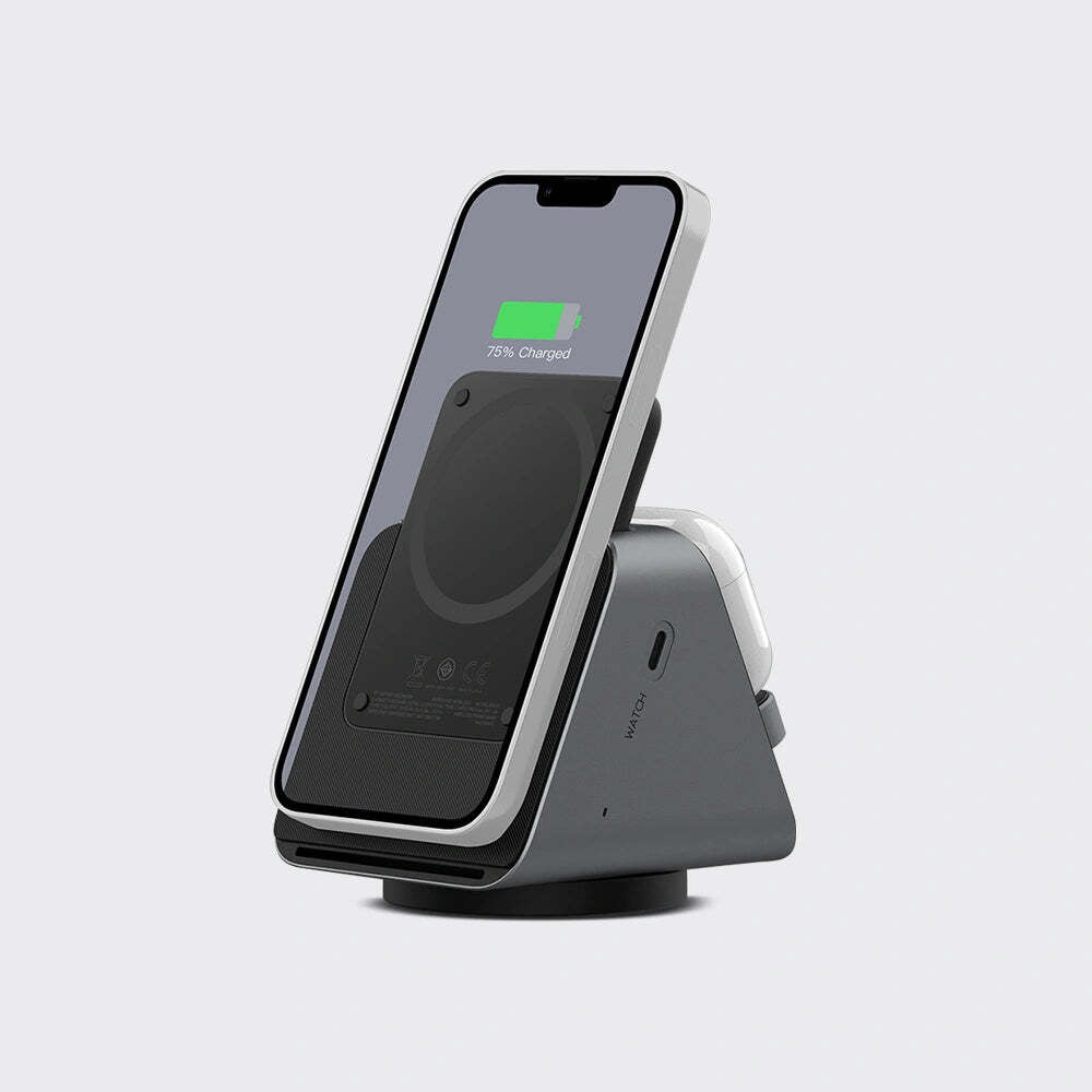A dark gray and silver wireless charging stand holding a smartphone, shown on a light gray background.