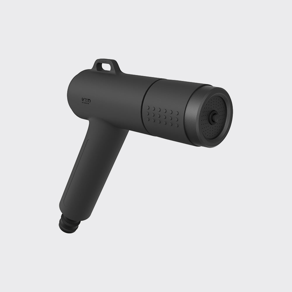 A matte black handheld massage gun with a carrying loop and textured nozzle, shown on a light gray background.