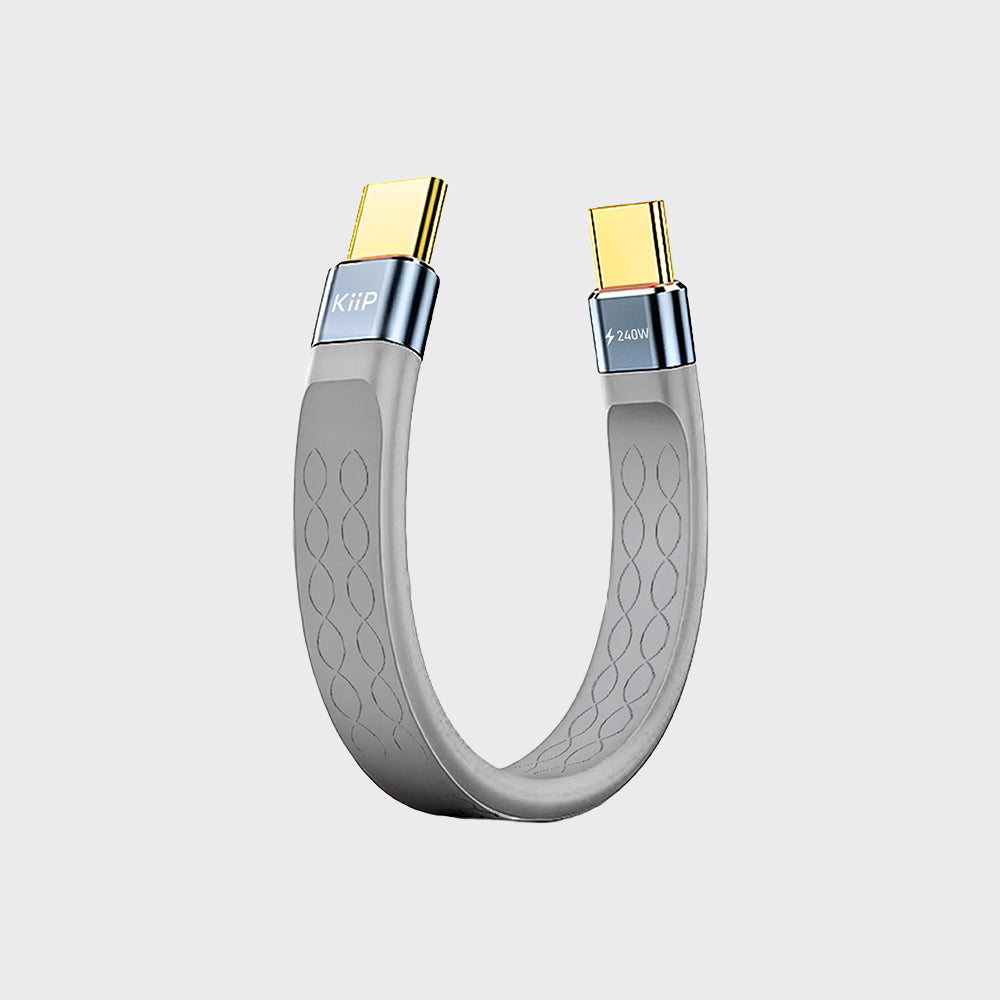A curved USB-C to USB-C data and power cable with a gray silicone body, textured grip pattern, and gold-plated connectors, shown on a light gray background.